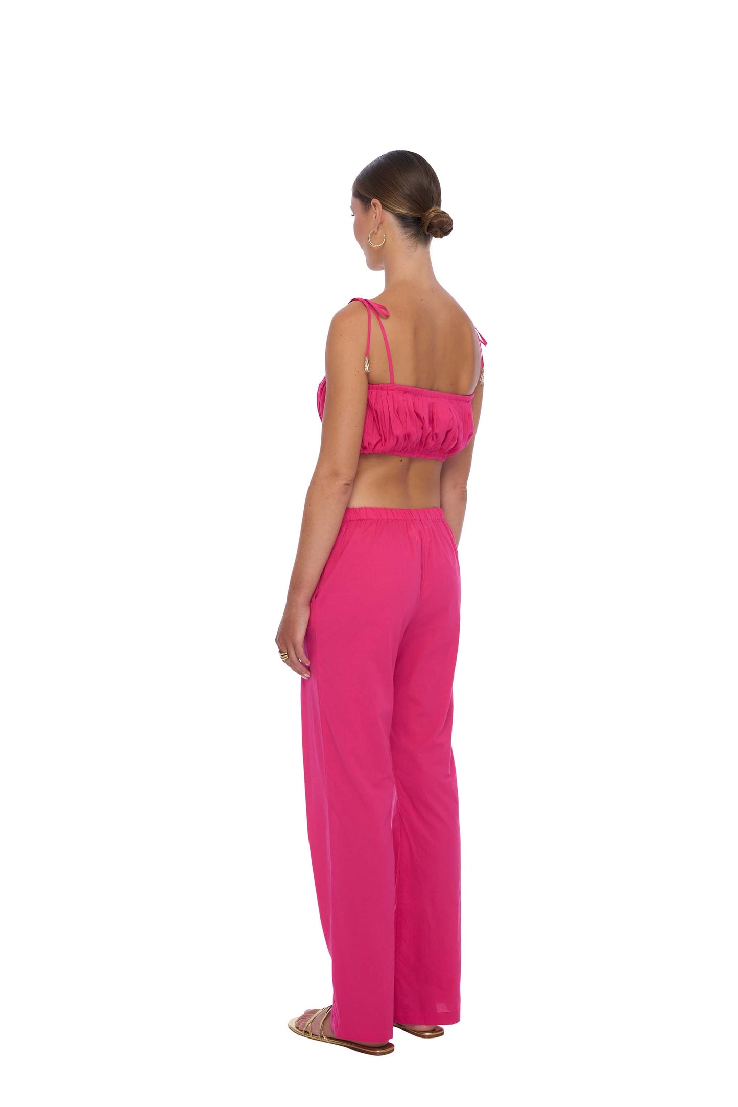 Trendy Demi Crop Top in soft Cotton Voile fabric featuring a ruched design with elasticated details, adjustable tie straps adorned with hand-beaded tassels and side zip closure. Perfect for a modern, casual look